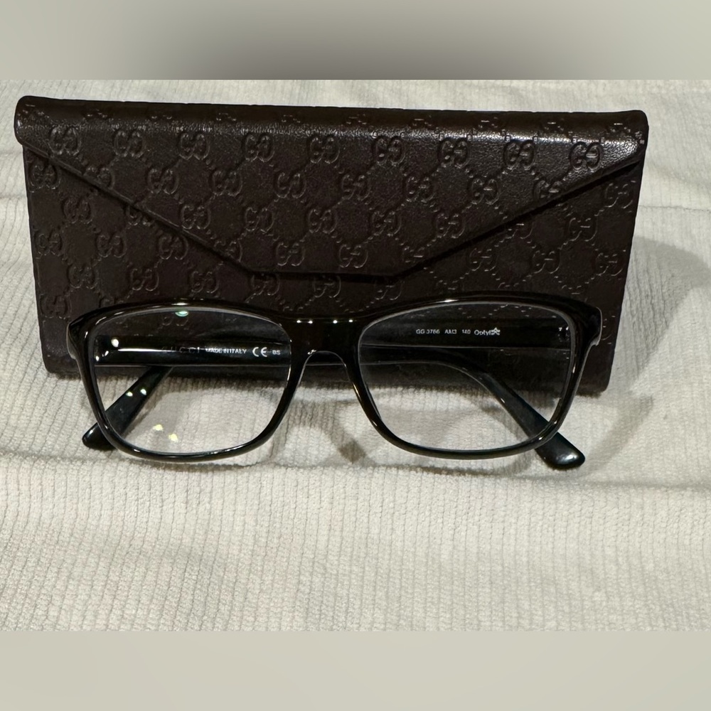 Gucci eyeglasses with Gucci eyeglasses case. Excellent condition. Black and gold
